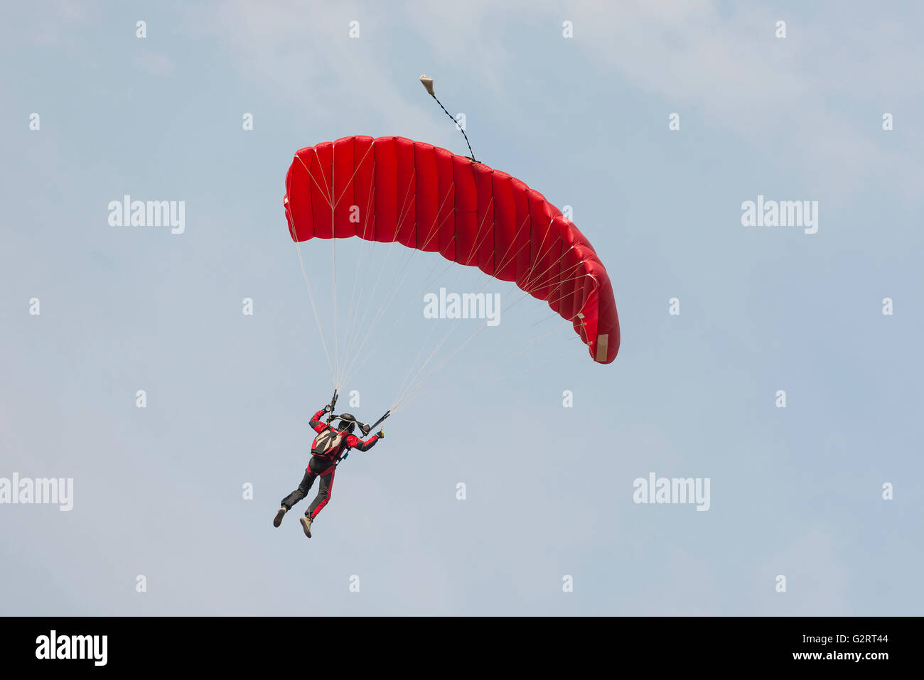 Parachutist floating to a square-shaped parachute Stock Photo - Alamy