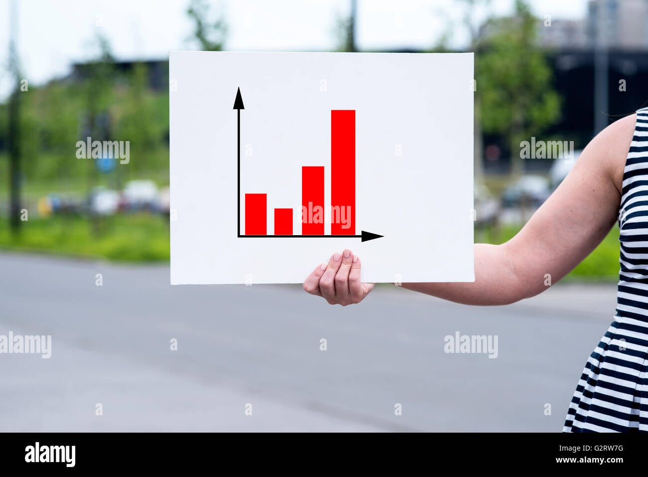 a picture of a woman presenting statistical reports and analysis charts ...