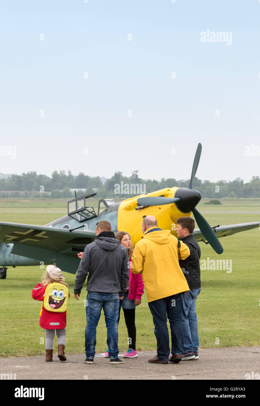 World War 2 education. A family with children looking at a vintage WW2 plane, Duxford Airshow, Imperial War Museum Duxford IWM, Cambridgeshire UK Stock Photo