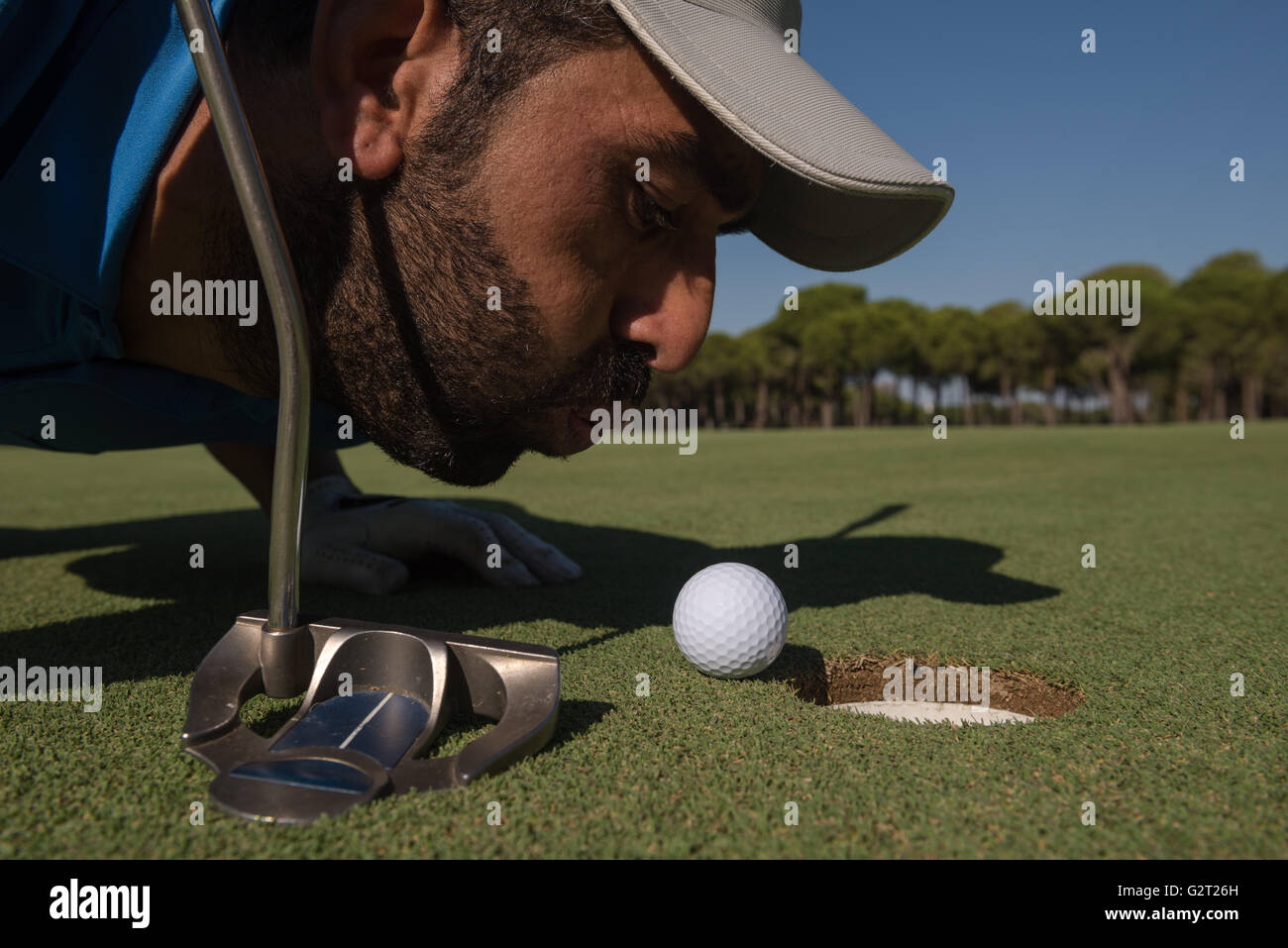 golf player blowing ball in hole. concept of cheating and success Stock  Photo - Alamy
