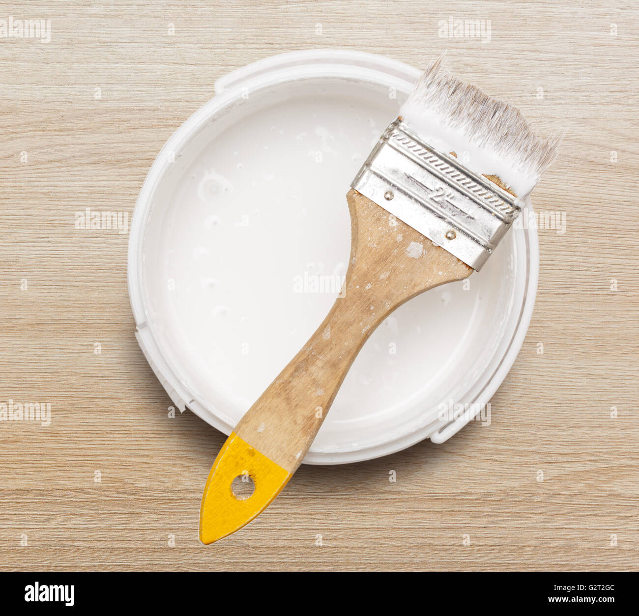 Open can of white paint with brush Stock Photo Alamy