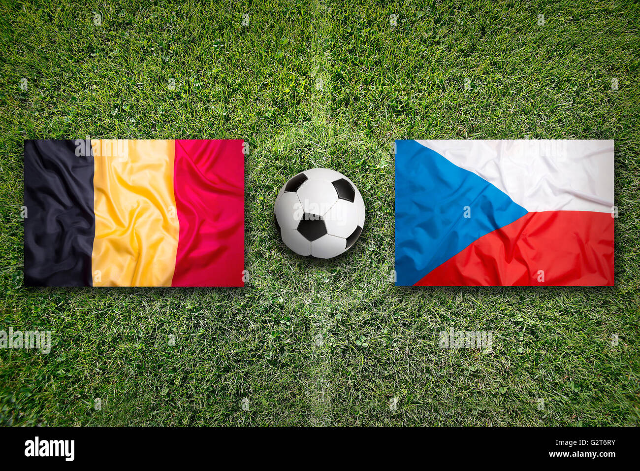 Belgium vs. Czech Republic flags on a green soccer field Stock Photo