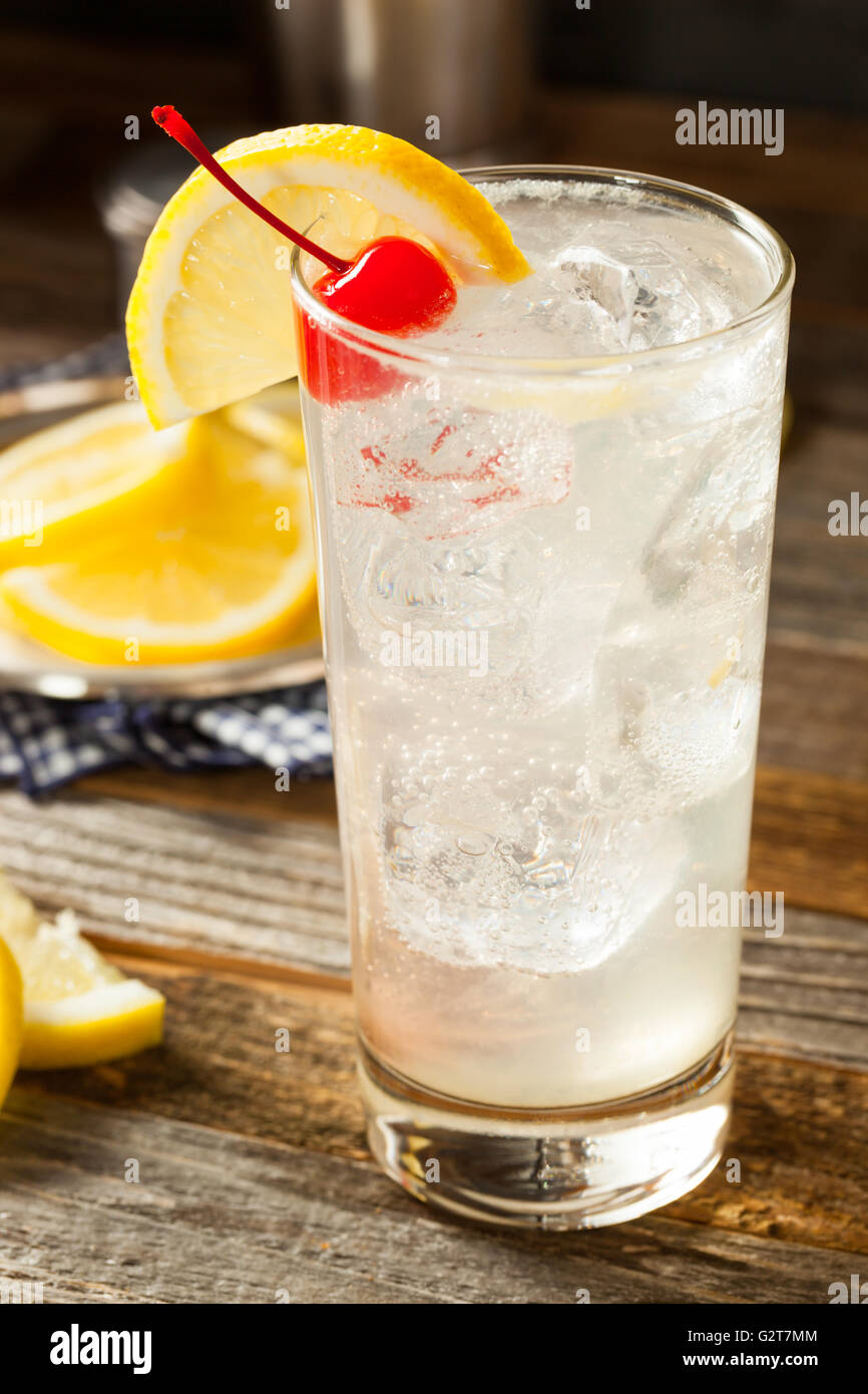 Refreshing Classic Tom Collins Cocktail with a Cherry and Lemon Slice Stock Photo