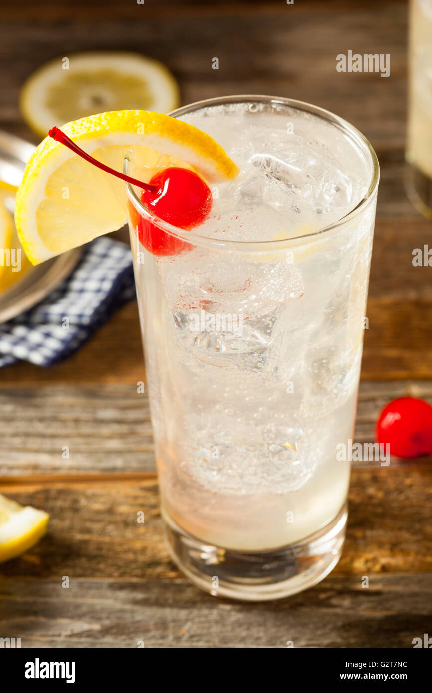 Refreshing Classic Tom Collins Cocktail with a Cherry and Lemon Slice Stock Photo