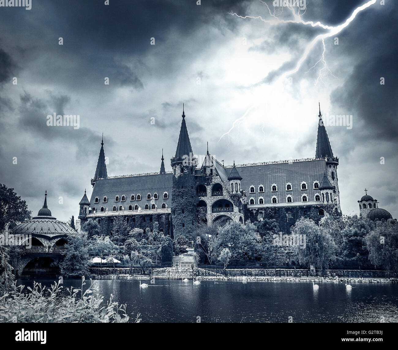 Lightning in the dark sky over the old stone castle. Stock Photo