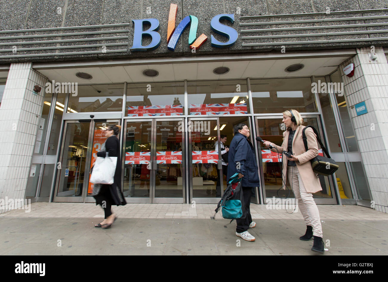 A journalist attempts to interview staff leaving a BHS store in Wood Green,  London as the retailer is to disappear from the high street, resulting in  the loss of up to 11,000
