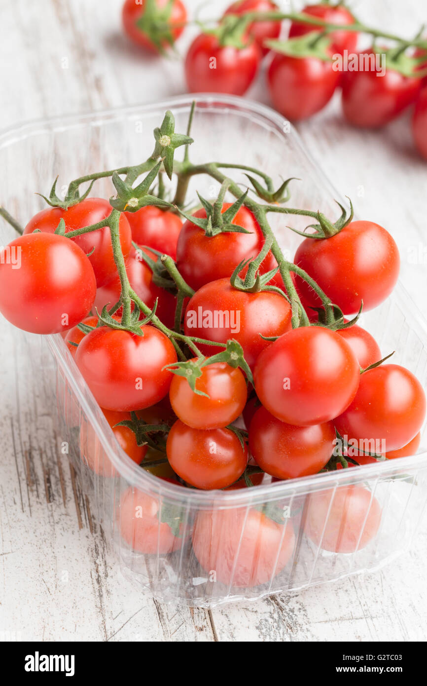 Fresh cherry tomatoes in a plastic box Stock Photo