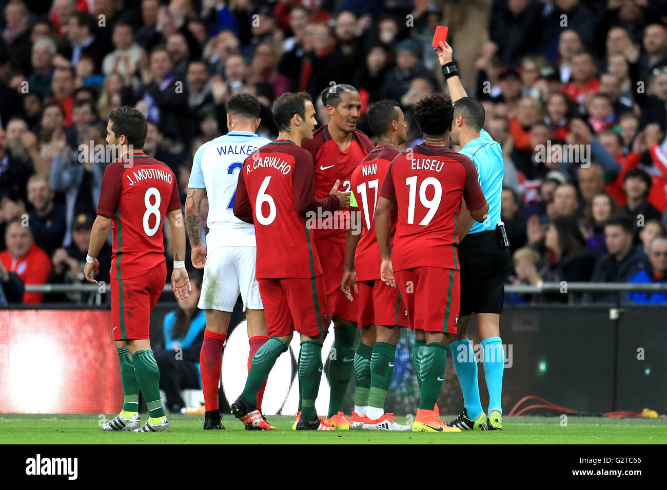 Portugal's Bruno Alves (centre) is shown the red card by referee Marco ...