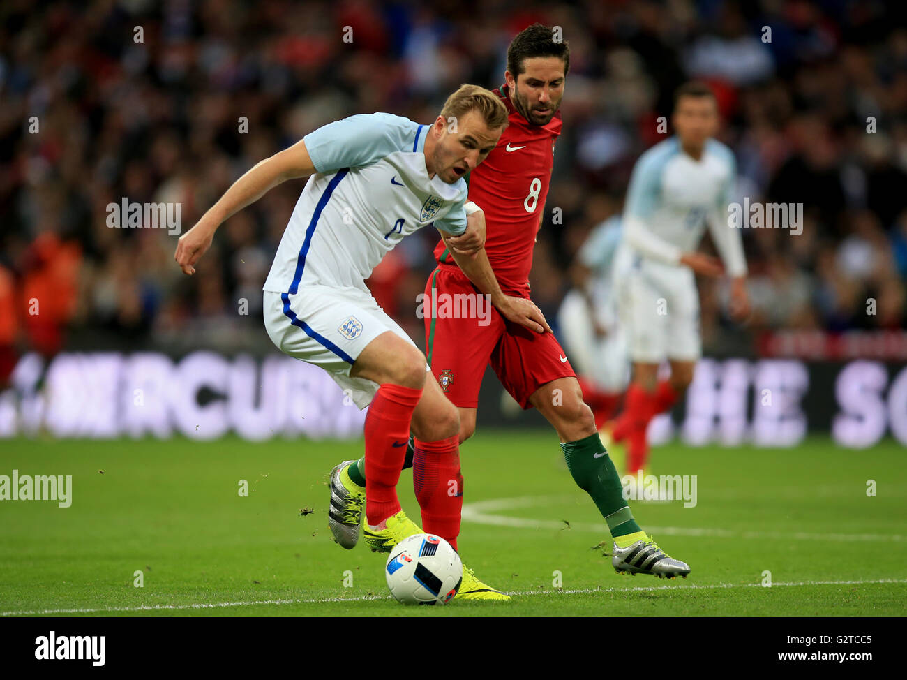 England's Harry Kane and Portugal's Joao Moutinho (right) battle for the ball during an International Friendly at Wembley Stadium, London. Stock Photo