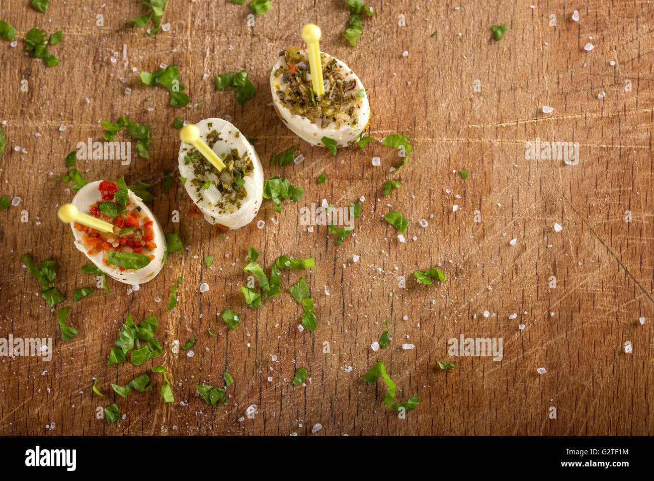 Set of tasty canape on a wooden background with herbs Stock Photo