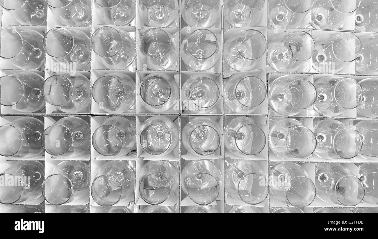 New transparent wine glasses in a cardboard grid package in a store. Stock Photo
