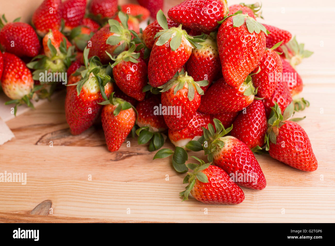 strawberries on a wooden table, studio picture Stock Photo - Alamy