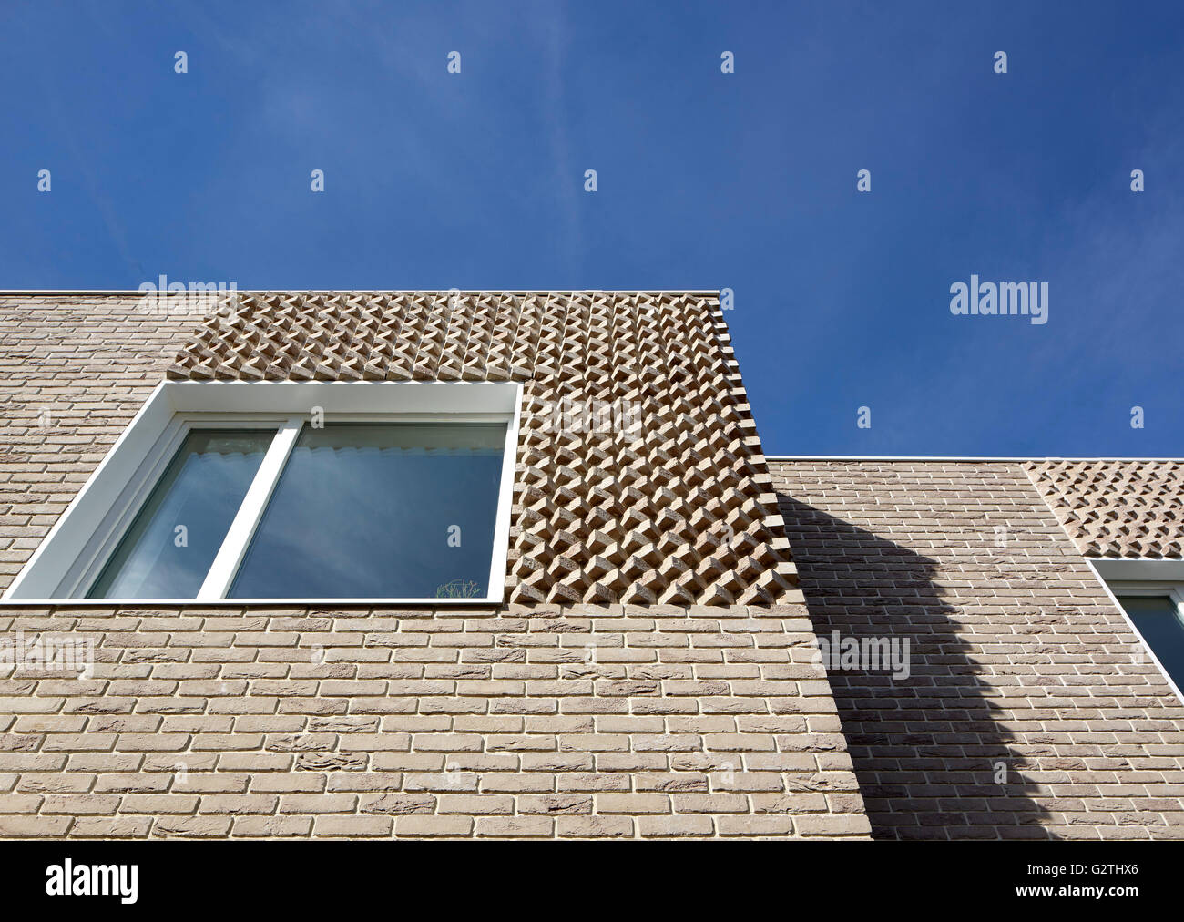 Looking up at facade. Hindman's Yard, London, United Kingdom. Architect