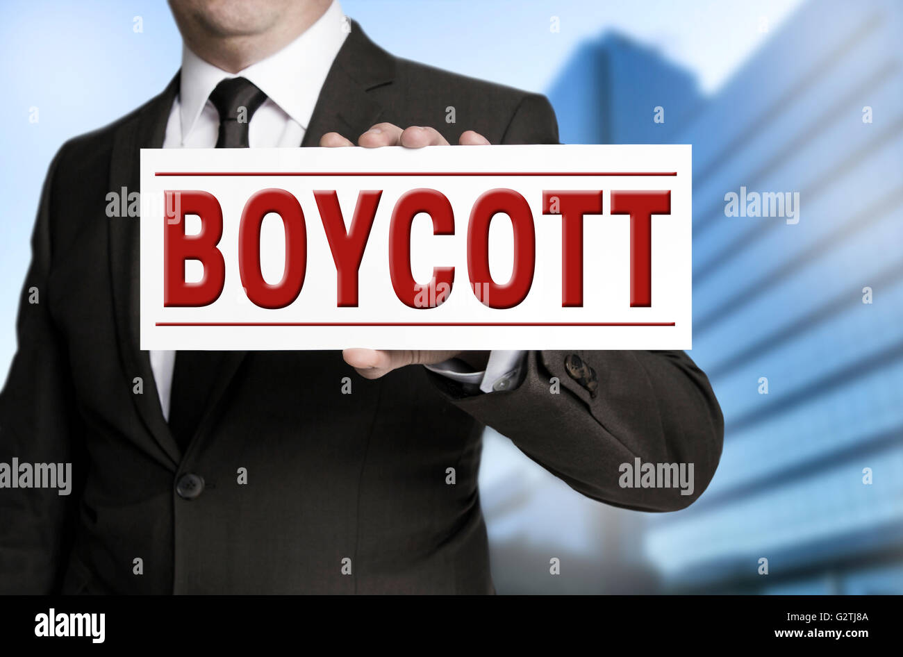 boycott shield is held by businessman. Stock Photo