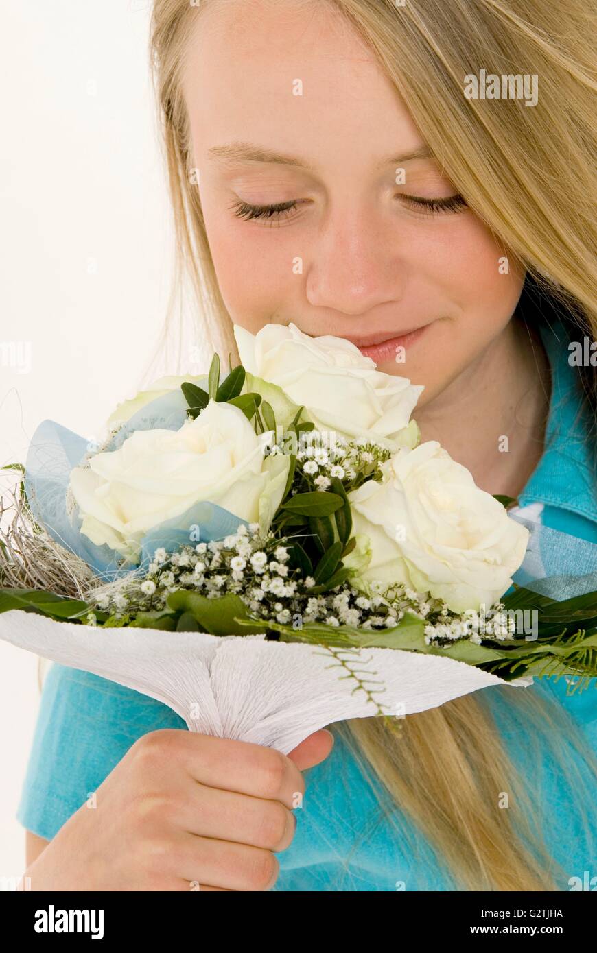 Young girl smelling bouquet of white roses Stock Photo Alamy