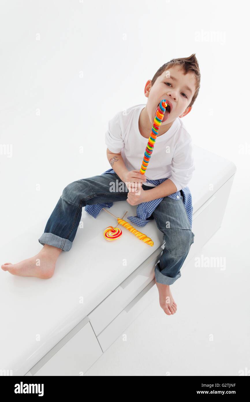 A little boy eating a giant lolly Stock Photo