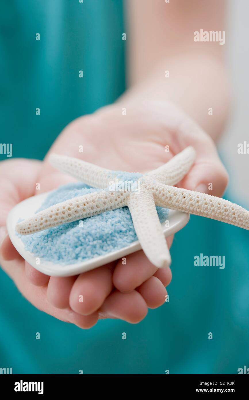Young woman holding bath salts with starfish Stock Photo