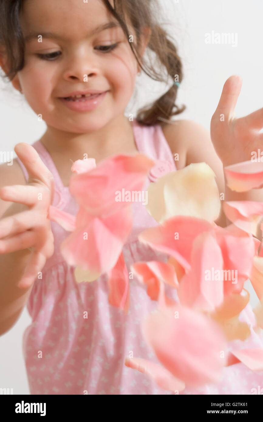 Pretty girl throwing rose petals Stock Photo Alamy