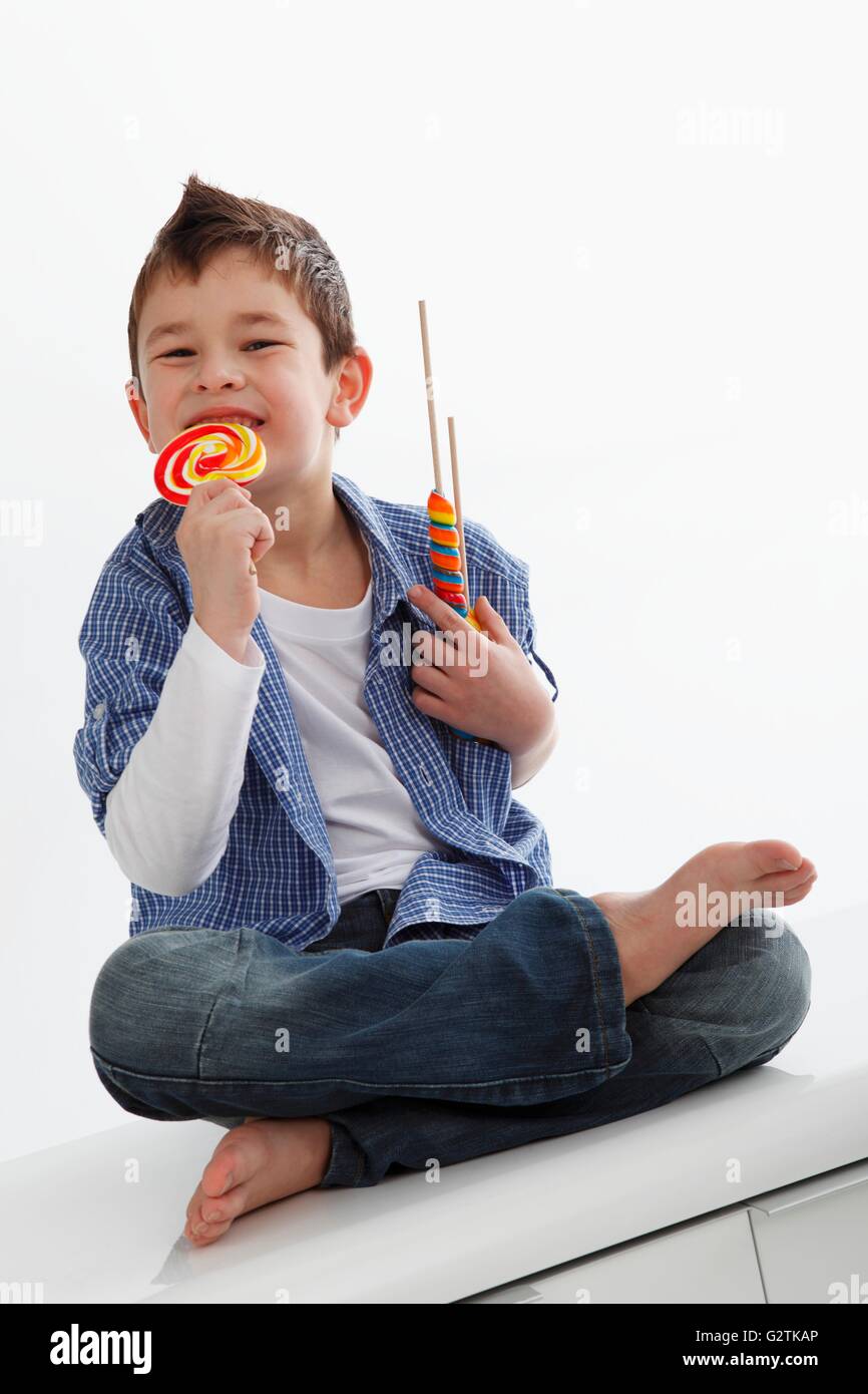 A little boy eating a lolly Stock Photo