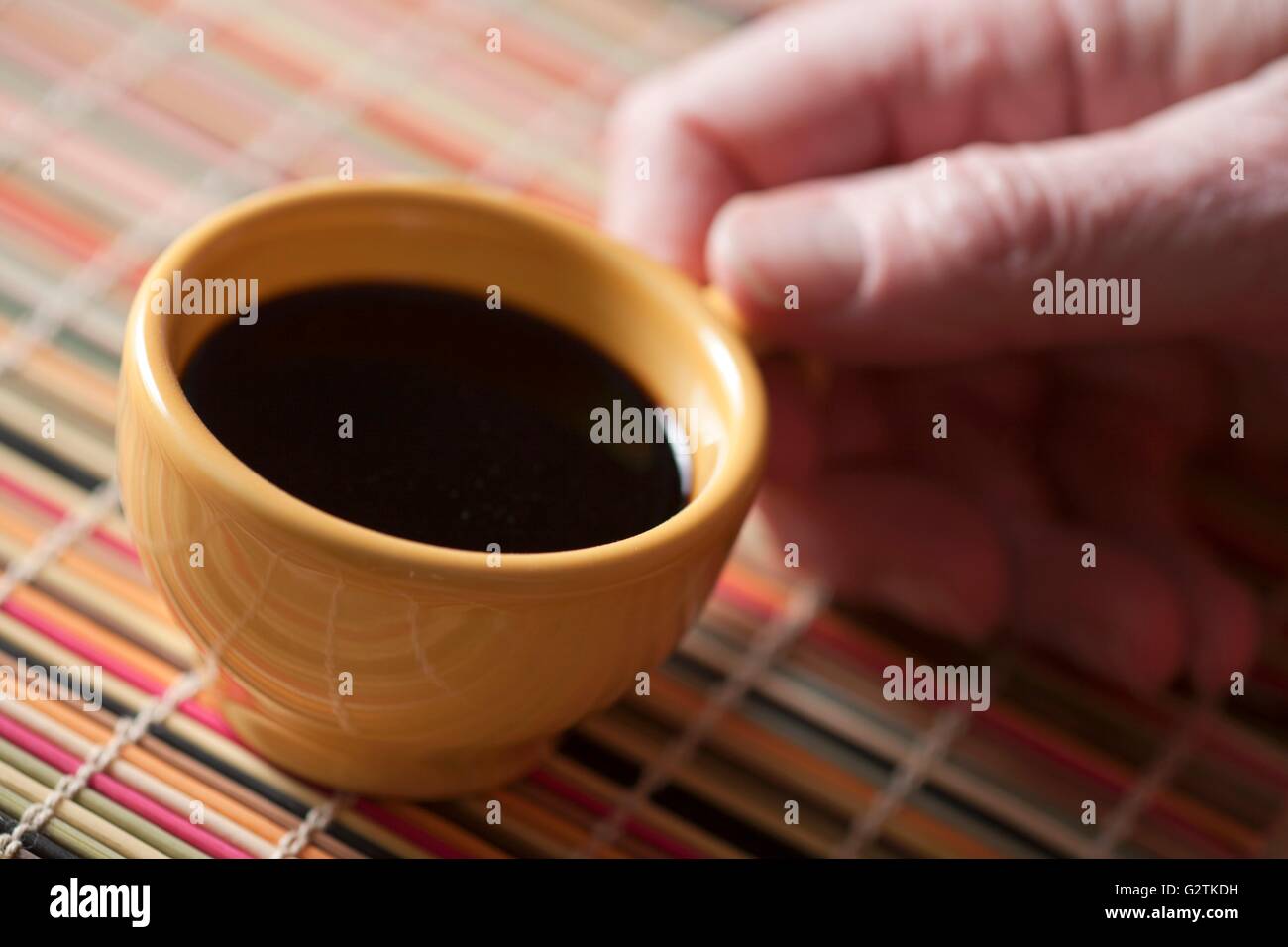 Hand Holding an Espresso Cup Stock Photo - Alamy