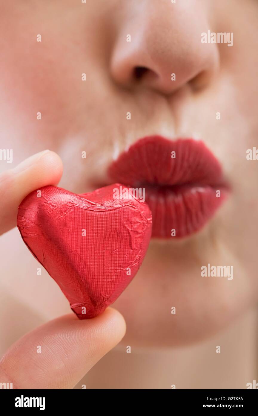 Red chocolate heart and kissing lips Stock Photo Alamy