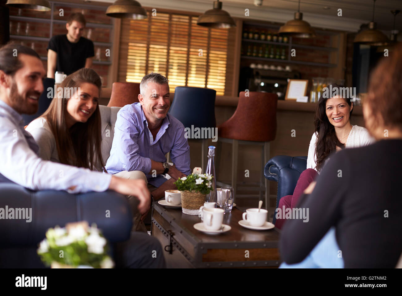 Group Of Friends Meeting For Coffee In Bar Stock Photo