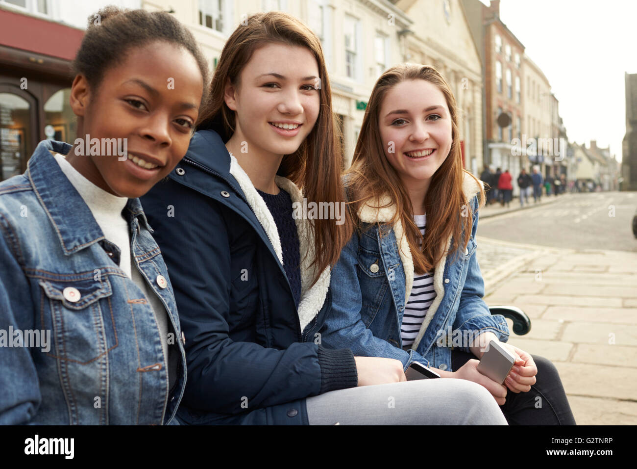 Portrait Of Teenage Girls Hanging Out In City Centre Stock Photo