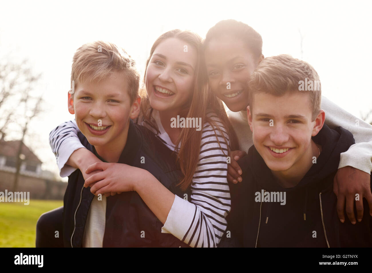 Portrait Of Teenage Friends Hanging Out In Park Together Stock Photo