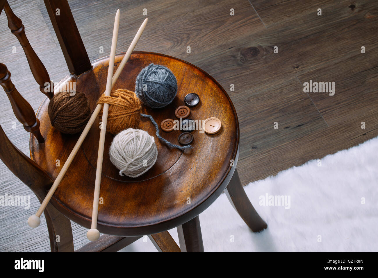 button and yarn ball on wooden chair, handmade Stock Photo - Alamy
