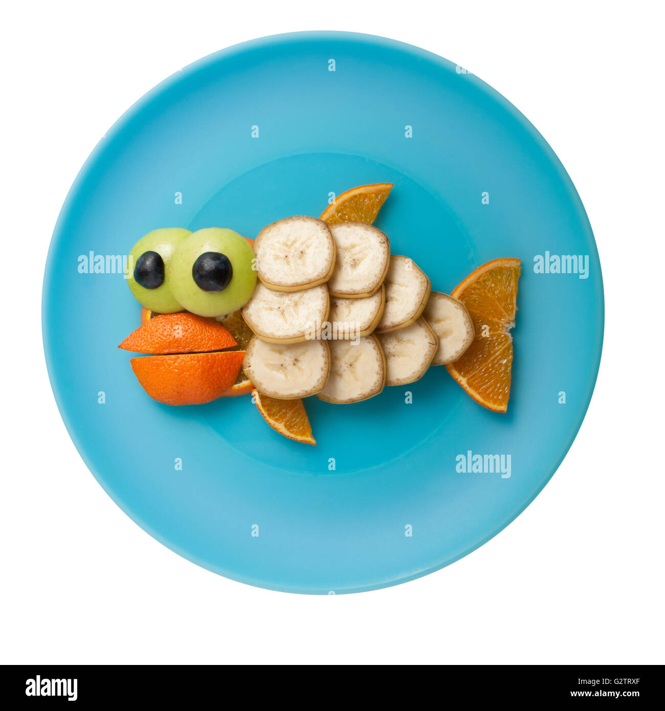 Fish made of fruits on blue plate Stock Photo Alamy