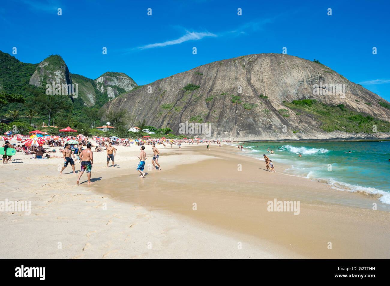 RIO DE JANEIRO - OCTOBER 31, 2015: Young Brazilians play altinho beach football on the shore of Itacoatiara Beach. Stock Photo