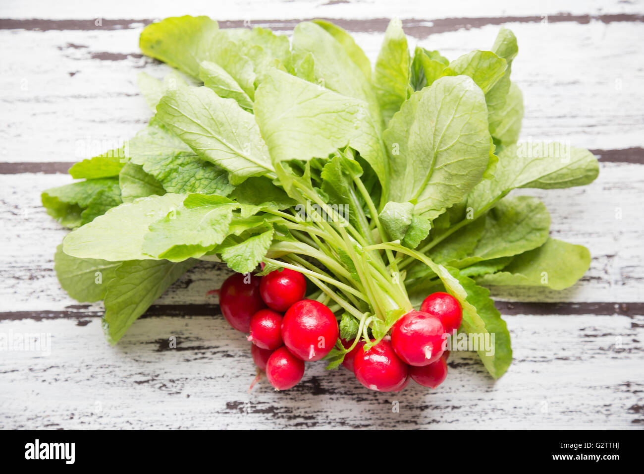 Little red turnips on a wooden table Stock Photo