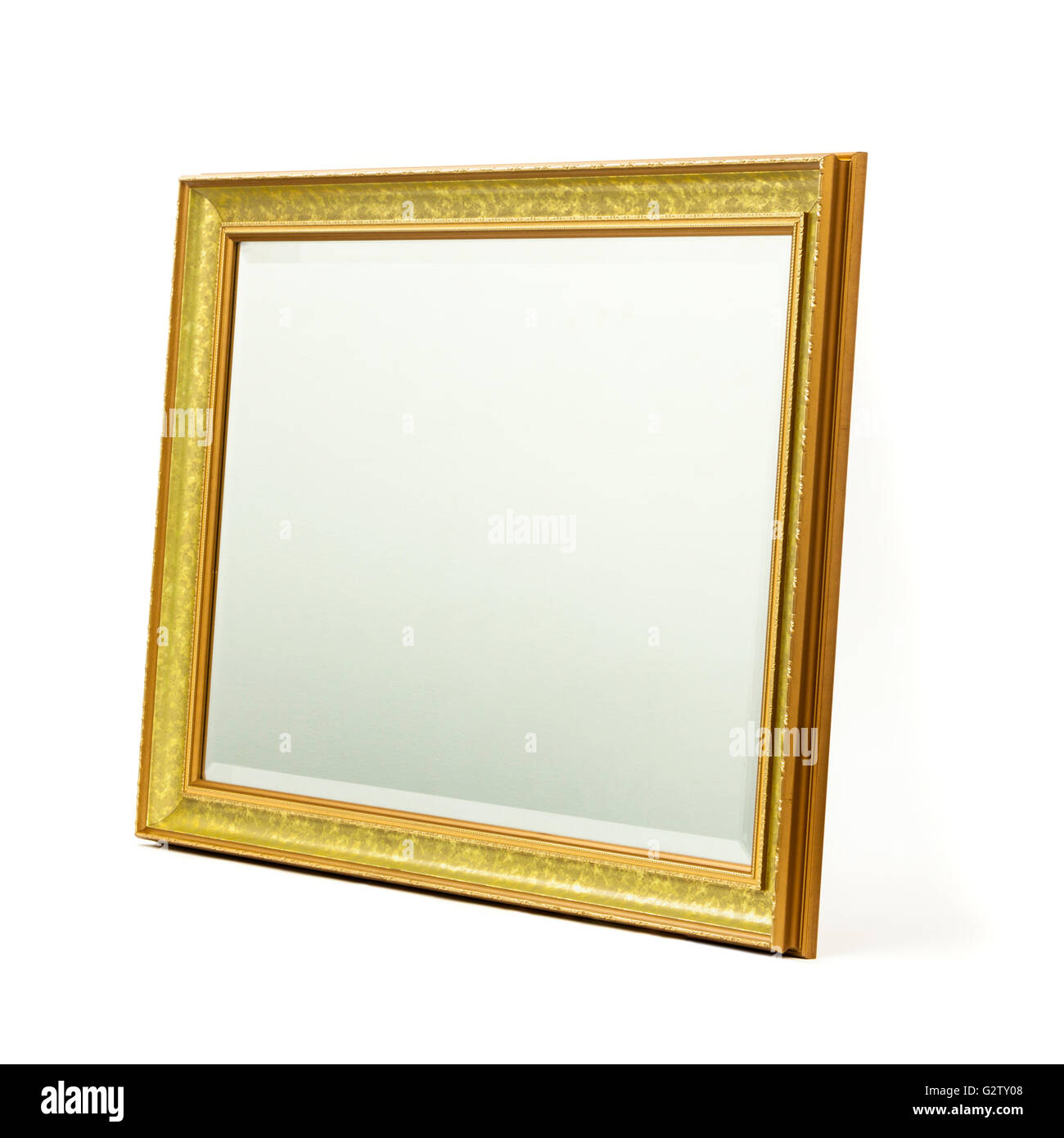 Bevelled glass mirror in gilded wooden frame Stock Photo