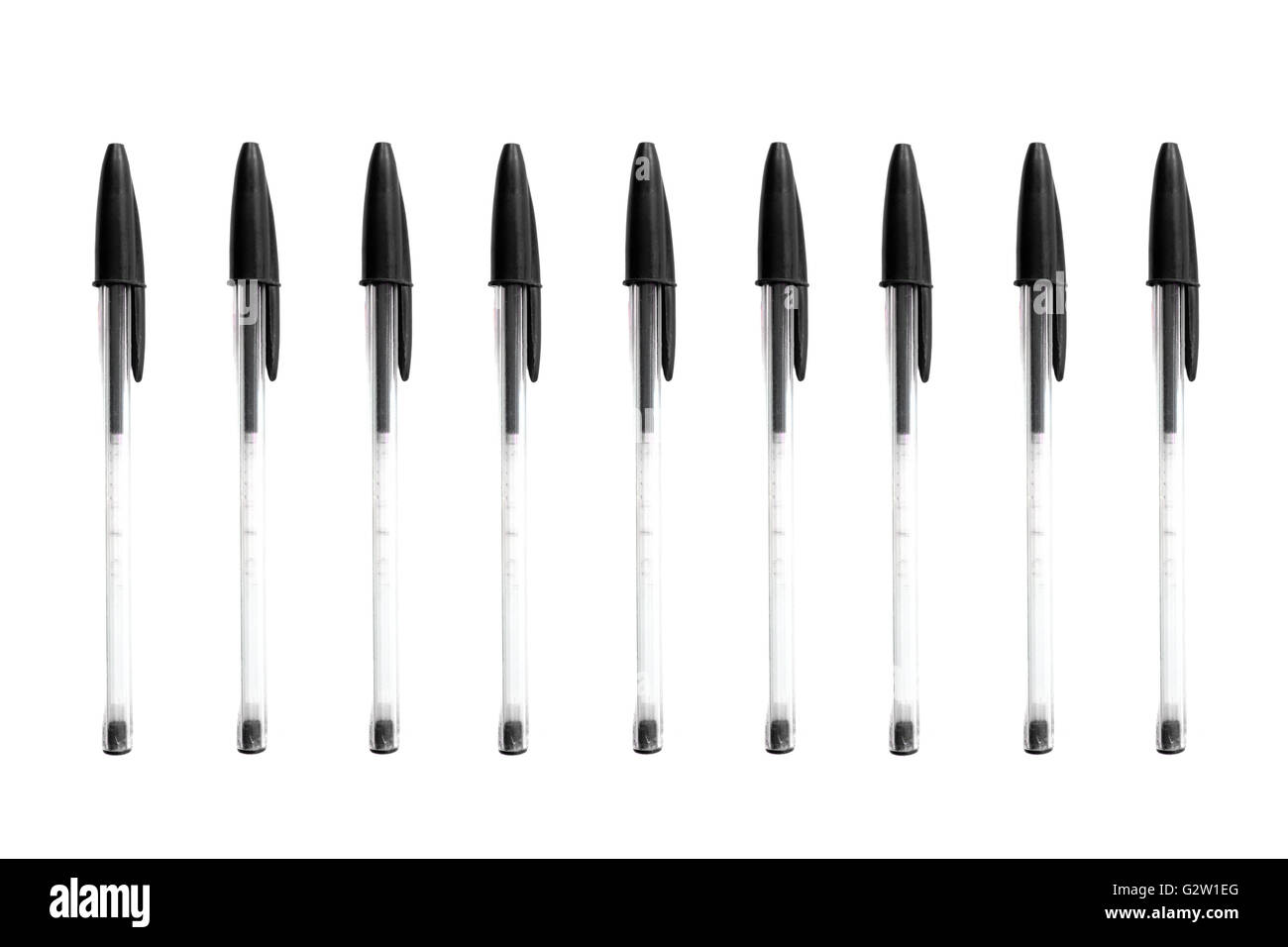 Black biro pens photographed against a white background. Stock Photo