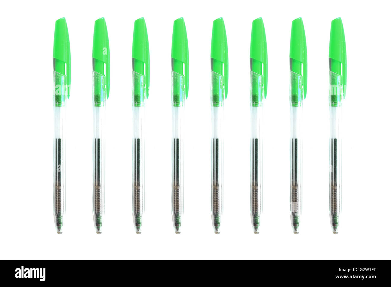 Green biro pens photographed against a white background. Stock Photo