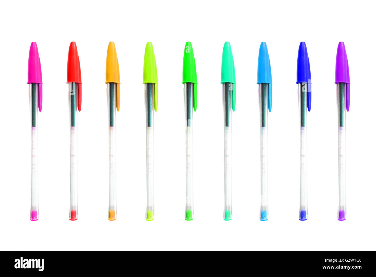 Biro pens in a rainbow of colours photographed against a white background. Stock Photo