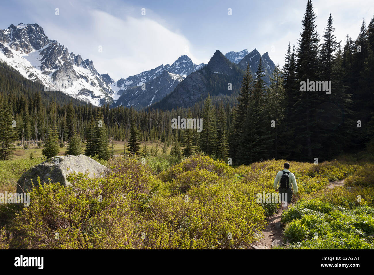 Alpine Lakes Wilderness, Washington: Man hiking the Stuart Lake Trail along the Stuart Range. Stock Photo