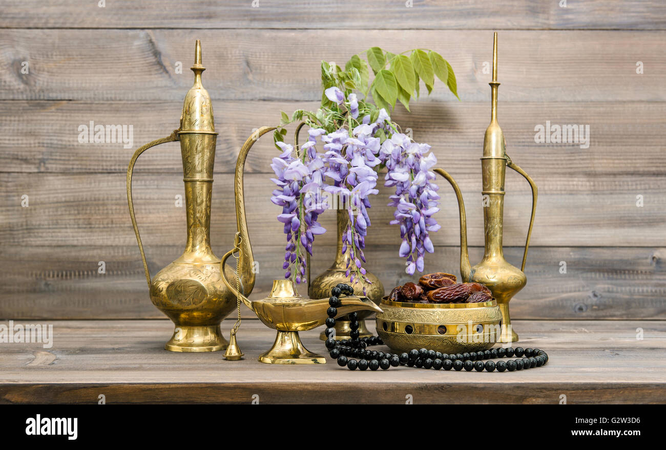 Vintage arabic jug, vase, lamp, tea pot, islamic rosary beads. Fruits and flowers. Oriental holidays decoration. Ramadan kareem Stock Photo