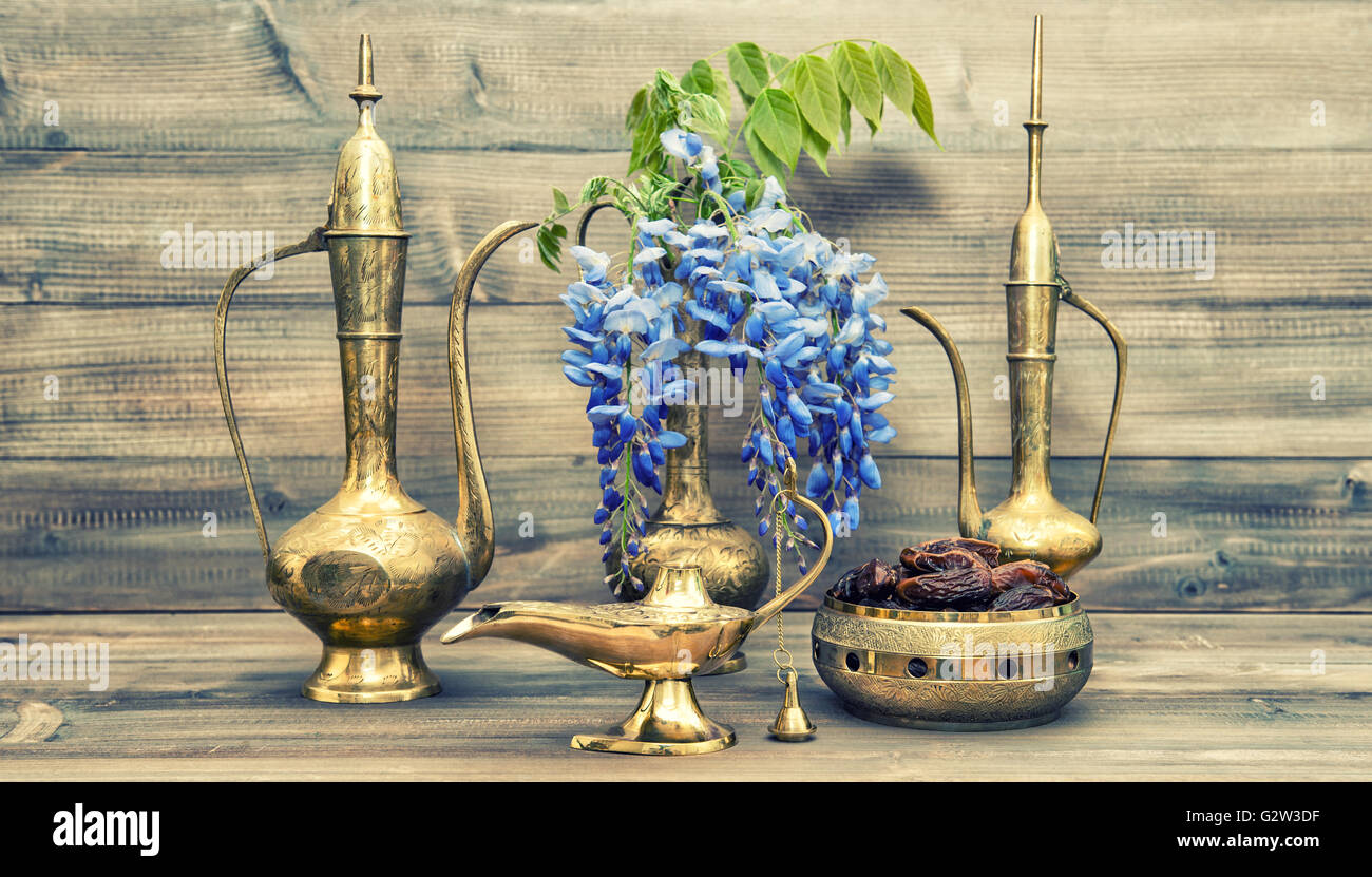 Antique arabic jug, vase, lamp, tea pot. Fruits and flowers. Golden oriental decorations. Vintage style toned picture Stock Photo