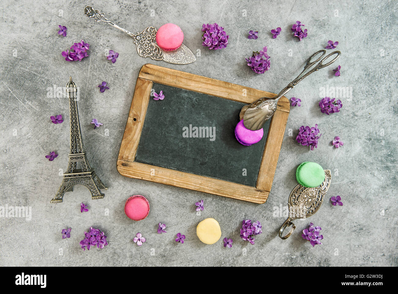 Vintage chalkboard, macaroon cookies, Eiffel tower Paris souvenir. Antique decorations Stock Photo