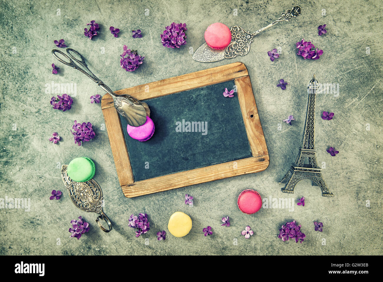 Antique chalkboard, macarons, Eiffel tower Paris souvenir. Vintage style toned picture Stock Photo