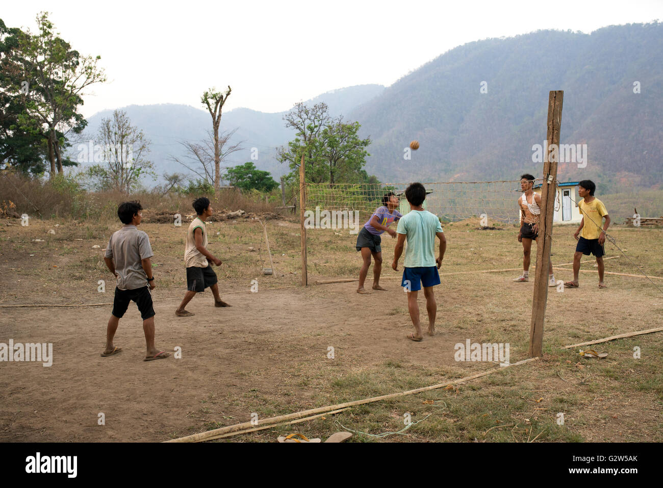 Boys playing kick volleyball (sepak takraw) with a rattan ball, Kayan State, Myanmar Stock Photo