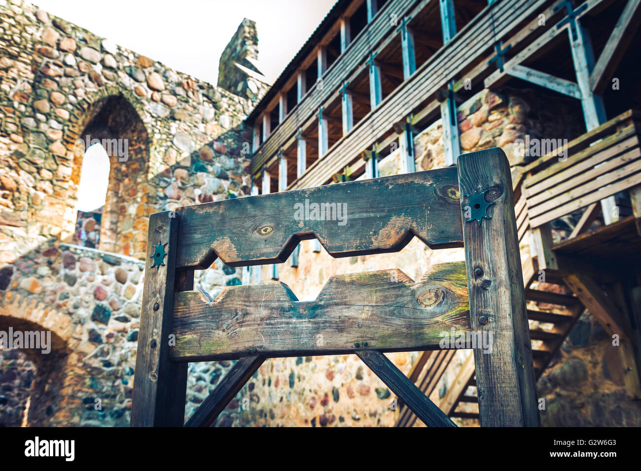 Wooden medieval torture device, ancient pillory in old castle. Stock Photo