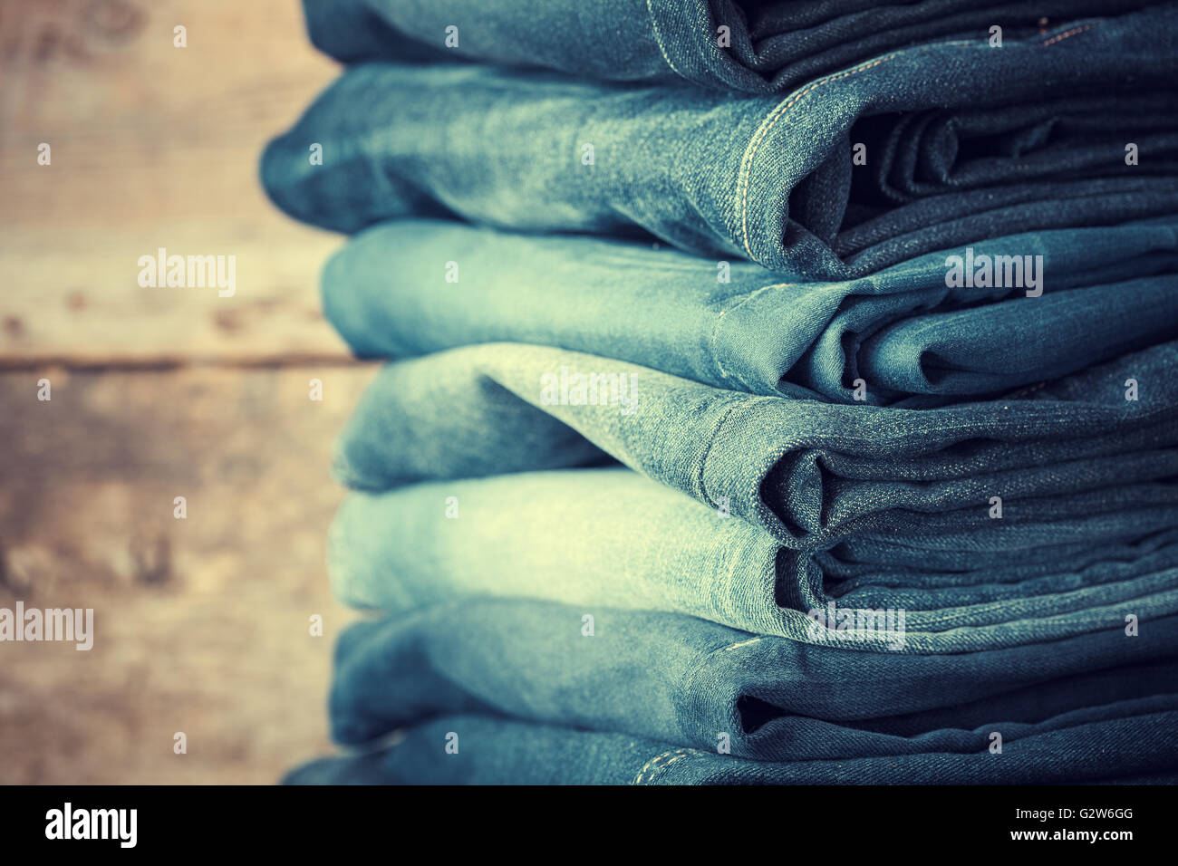 Stacked fashion jeans closeup. Retro toned. Stock Photo
