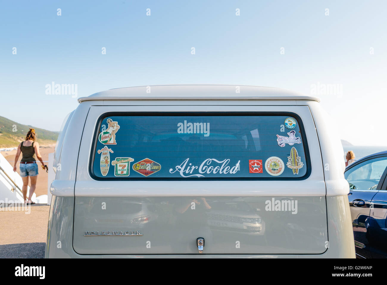 The back of a VW combi van with vintage stickers at the beach Stock Photo