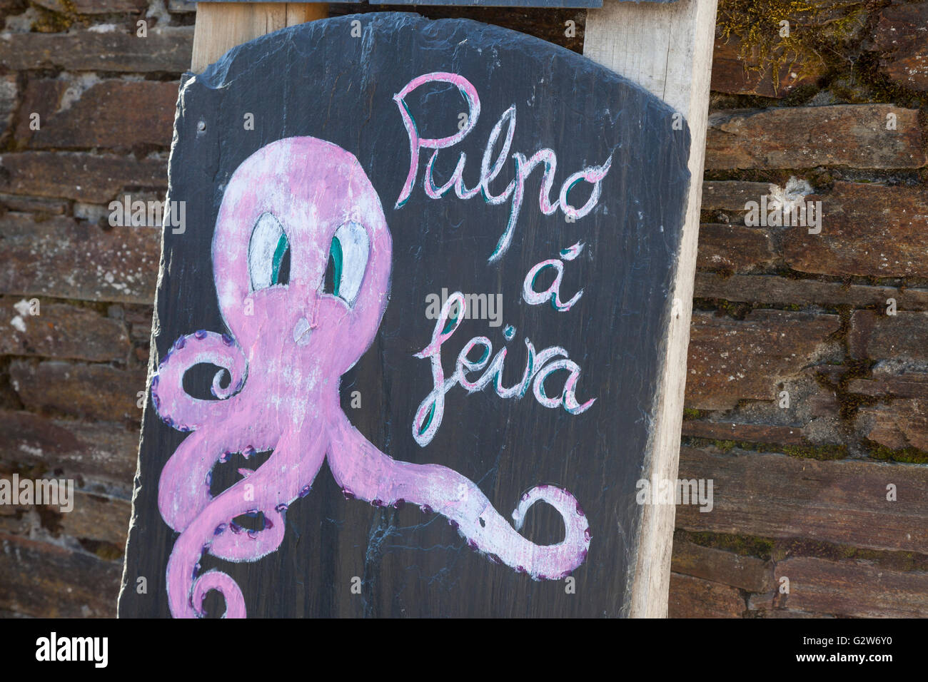 O Cebreiro, Spain: Sign advertising Pulpo á feira at a restaurant in the village. Stock Photo