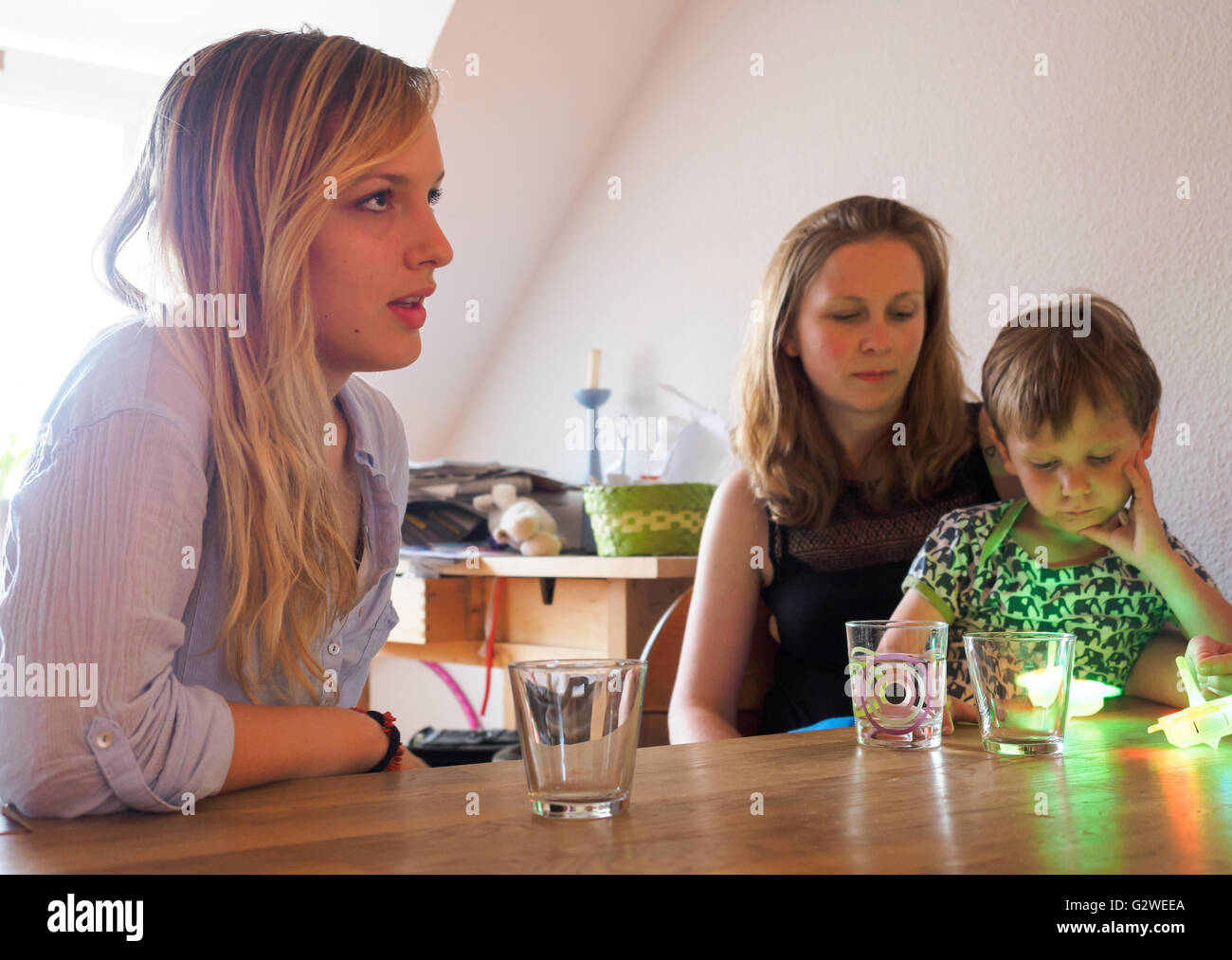 Katharina Frisch (C) sits with her four-year-old son Elija (R) and the ...