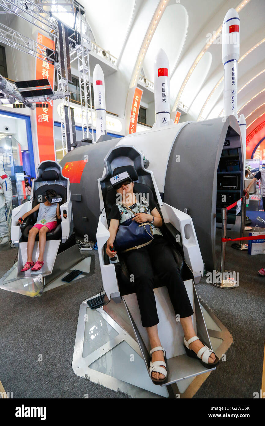 Beijing, China. 4th June, 2016. Visitors experience the extravehicular activity of astronauts through VR equipment during an exhibition on China's science and technology achievements during the 12th Five-Year Plan period (2011-2015) in Beijing, capital of China, June 4, 2016. Credit:  Shen Bohan/Xinhua/Alamy Live News Stock Photo