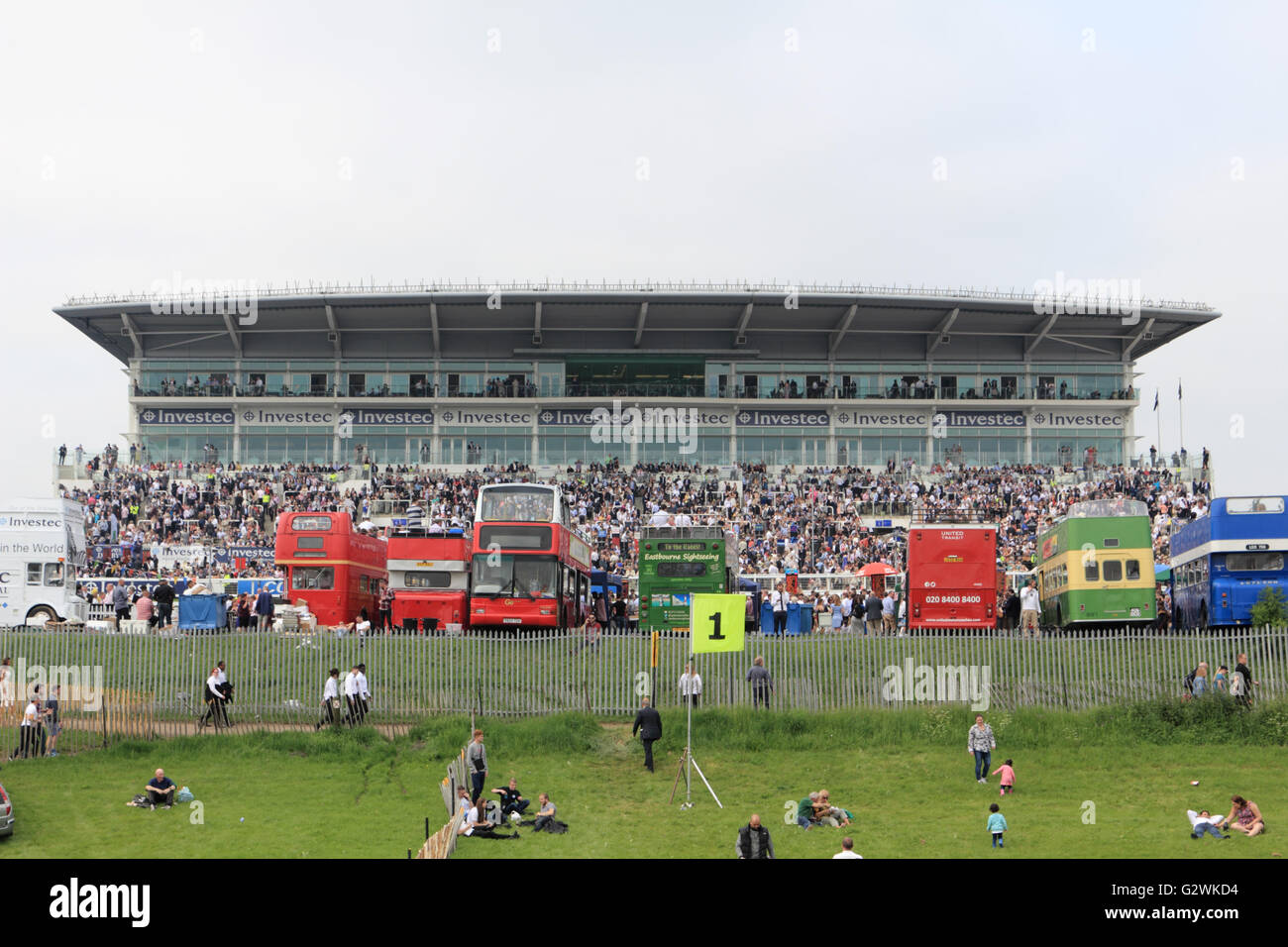 Epsom Downs, Surrey, England, UK. 4th June 2016. Open deck buses in front of the grandstand on Derby Day at Epsom Downs race course, where the world famous flat race the Investec Derby is the main race of the day. Stock Photo
