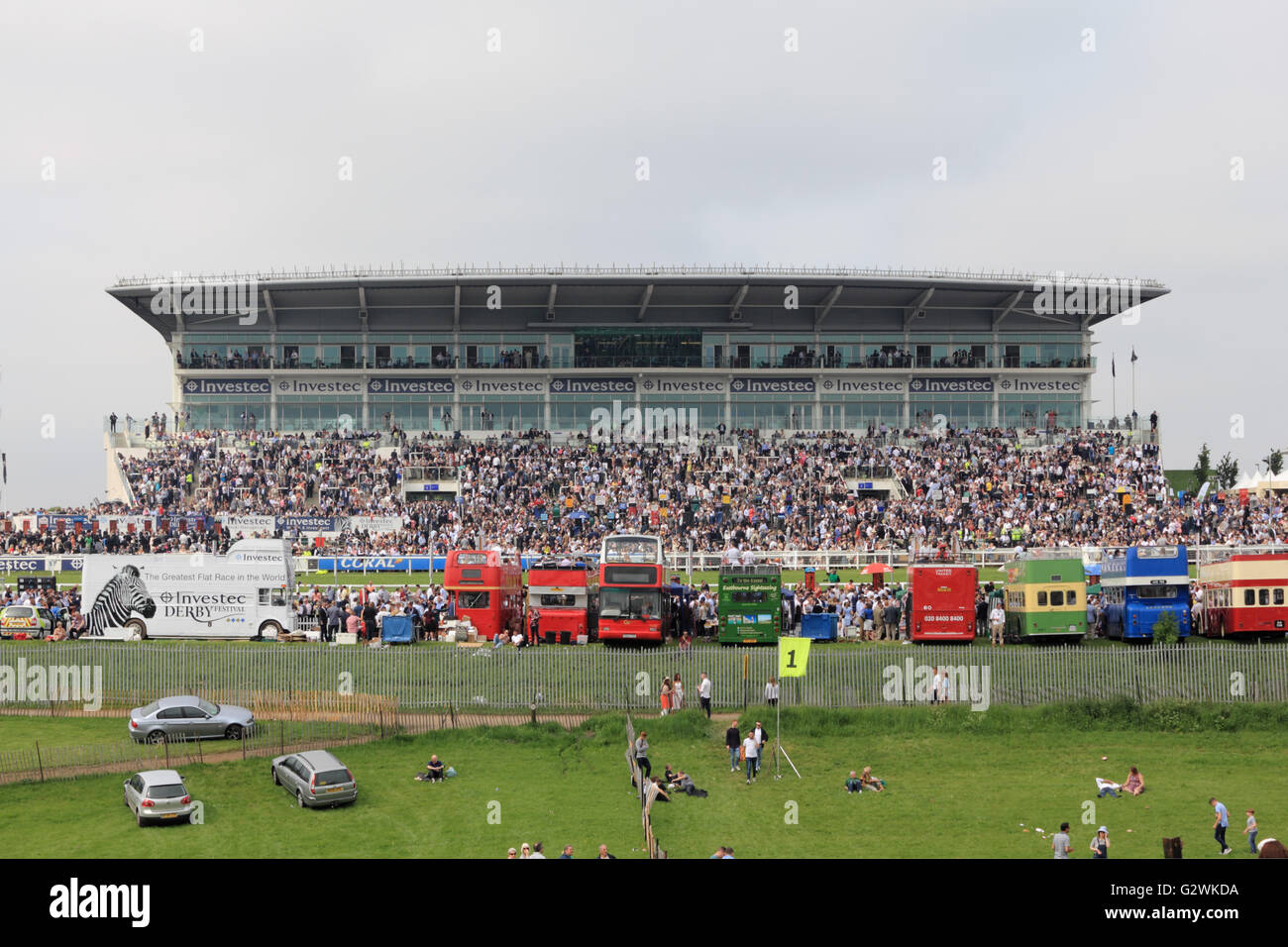 Epsom Downs, Surrey, England, UK. 4th June 2016. Open deck buses in front of the grandstand on Derby Day at Epsom Downs race course, where the world famous flat race the Investec Derby is the main race of the day. Stock Photo